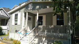 siding installation project on light green house